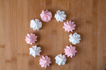 Biscuits meringue round frame on a wooden table. High quality photo