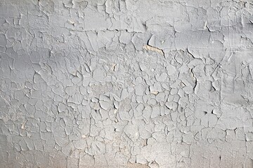old gray shabby wall in the sun with cracked paint, which is cracked, background, blank for design