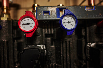 Heating system under construction with a view to the thermometers of the heating circuits.