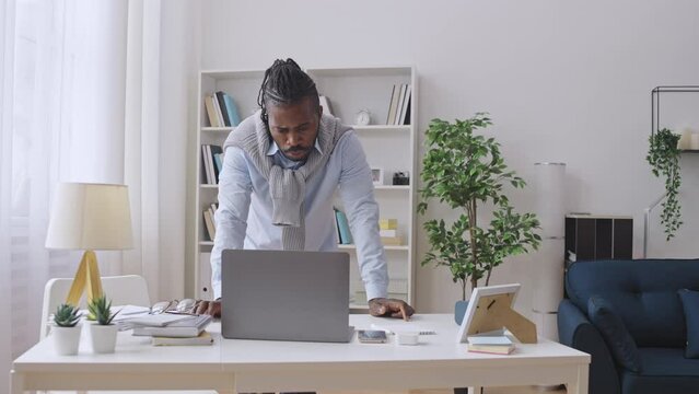Preoccupied black man working on project for too long, lack of inspiration
