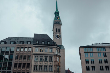 Fototapeta premium Building with windows. Beautiful landmark in the city of Munich, in Germany. Tourist attraction. Clock