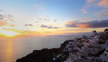 Fototapeta premium Beautiful of sunset view point the landmark of skyline with windmill and Church of Santorini. Oia town on Santorini island, Greece. Incredibly romantic sunset on Santorini.