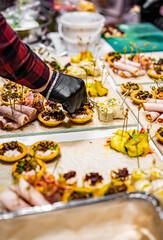 Chef hand is in process of Preparing catering food on table