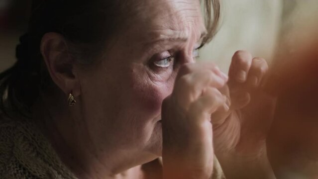 Elderly woman crying, closeup view