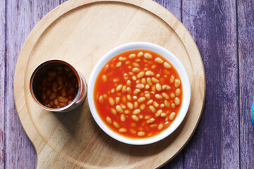 Tasty baked beans in a bowl on orange background ,