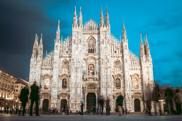 Milan Cathedral , Duomo di Milano, is the gothic cathedral church of Milan, Italy. Shot in the dusk from the square ful of people