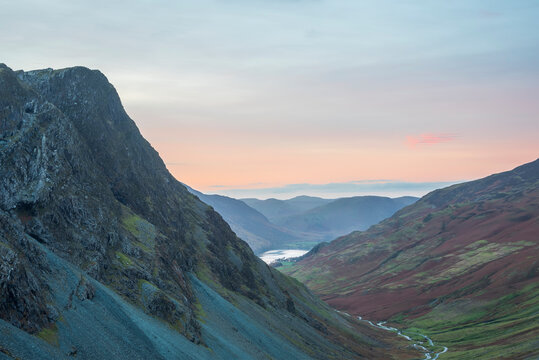 Stunning colorful landscape image of view down Honister Pass to Buttermere from Dale Head in Lake District during Autumn sunset