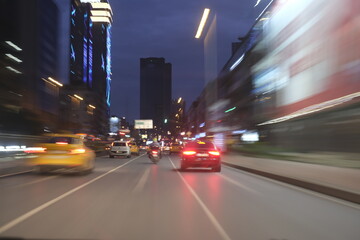 Colorful light trails during city night travel by car