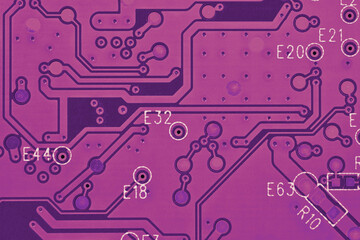 Hard drive HDD printed wiring board PWB closeup. Conductive patterns. Dark pink PC background. Purple red tinted computer wallpaper. Science and digital technologies. Strong macro