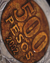 Translation: 500 pesos. Coin of 500 Chilean pesos close-up. Peso of Chile. News about economy or banking. Loan and credit. Wages and money. Vertical stories. Macro - obrazy, fototapety, plakaty