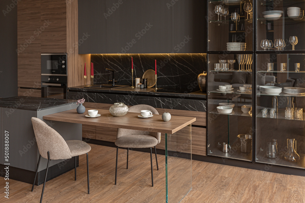 Wall mural kitchen area in a chic expensive interior of a luxury home with a dark black and brown modern design