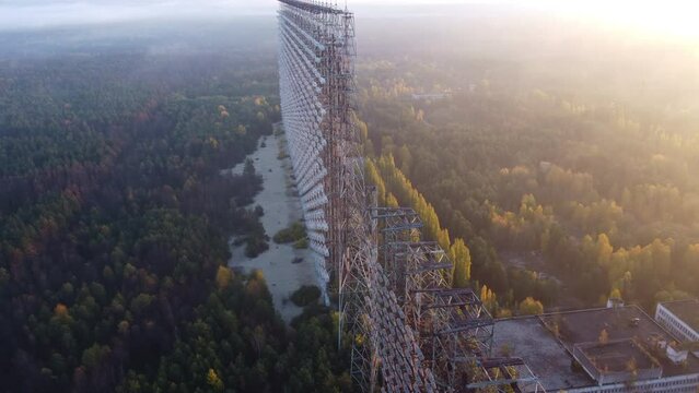 Drone footage of the top of the Duga radar in Chernobyl with dense forest below