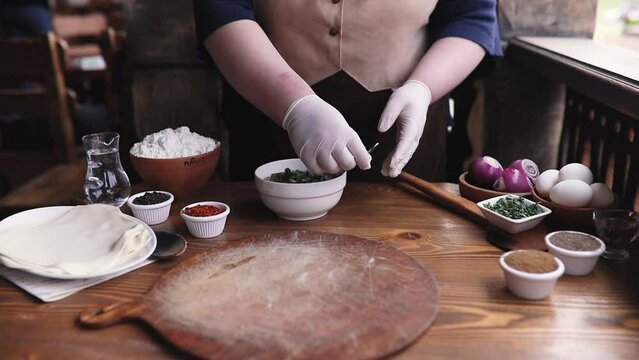 Georgian cuisine master class a female chef cooks khinkali in a restaurant. Traditional Caucasian food is khinkali.