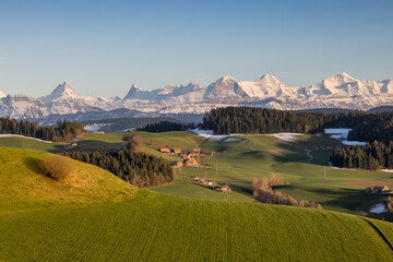 classical view over the hills of Emmental with the Bernese Alps in the Background
