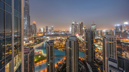 Fototapeta na wymiar Dubai downtown with fountains and modern futuristic architecture aerial night to day timelapse