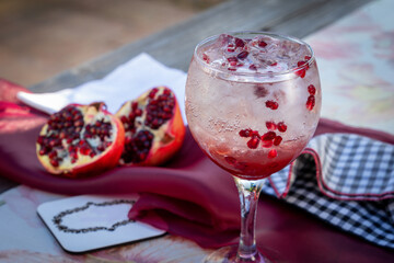 pomegranite cocktail drink on an outdoor table