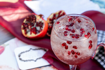 pomegranite cocktail drink on an outdoor table