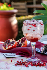 pomegranite cocktail drink on an outdoor table