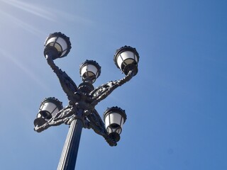 Fototapeta na wymiar Low angle view of lamp at Plaza de Zocodover, against blue sky.