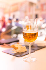 Glass of light beer on a table.