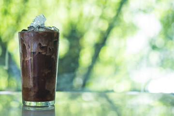 Iced coffee in tall glass with milk