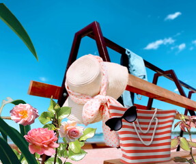 women beach handbag and  sunglasses  straw hat  on bench at sea blue sky ,  tropical flowers white clouds  nature summer holiday background