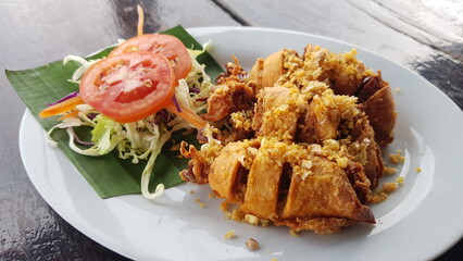 Fried stuffed squid in a white plate.