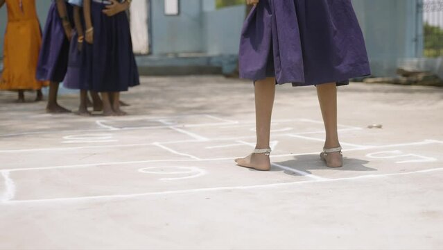 close up shot Group of school kids playing hopscotch during break time - concept leisure activities, learning and growth.