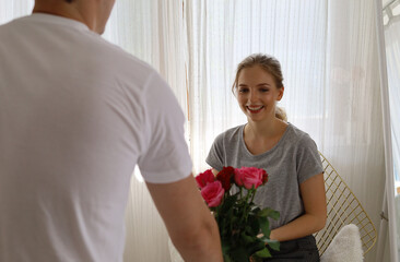 Happiness young couple lover surprise give rose flower in valentine's day.