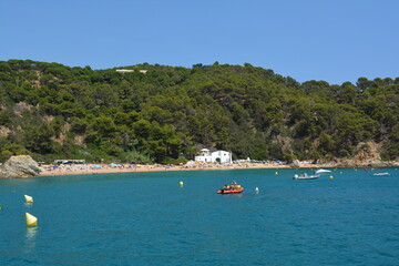 Fototapeta na wymiar The beach of Cala Canyelles in summer on a beautiful day, mediterranean sea