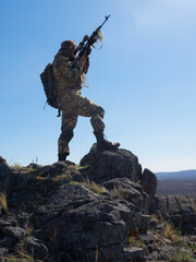 Professional special forces sniper during a special operation - he aims at the enemy. Concept of modern military operations and a special operation on enemy territory.