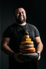 craftsmanship hands have a typical Italian cheese. French tomme cheese in the hands of a...