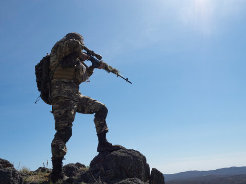 Professional special forces sniper during a special operation - he aims at the enemy.