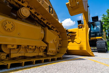 Bulldozer on the background of the excavator. Construction machines