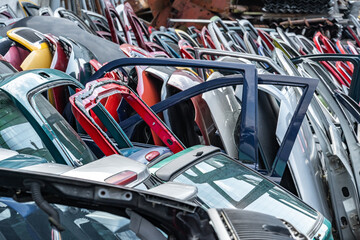 Fototapeta premium different colored car doors at a car junkyard