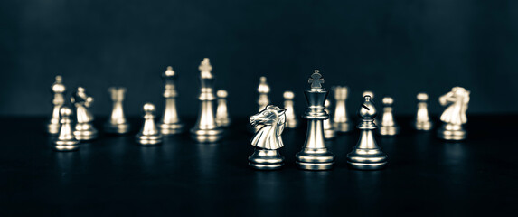 Close-up king chess standing on chessboard concepts of leader teamwork or volunteer or challenge of business team or wining and leadership strategy and organization risk management or team player.