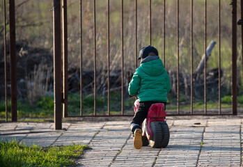 a child rides a bicycle in his yard in the spring