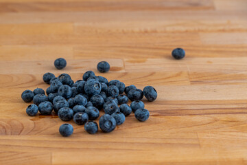 a small bunch of blueberries on a wooden table