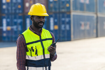 black african worker foreman staff working control load cargo with radio at port shipping.