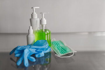 Blue medical gloves on the table, mask and medical disinfection containers. High quality photo