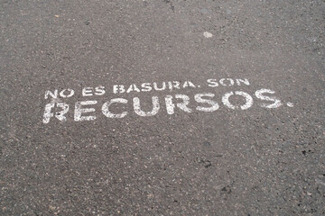 It is not garbage, it is resources. Recycling message painted on the asphalt.