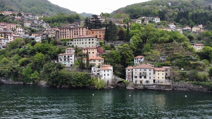 Beautiful view from the lake to the shore with villas. Old town with a bridge
