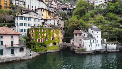 Beautiful view from the lake to the shore with villas. Old town with a bridge