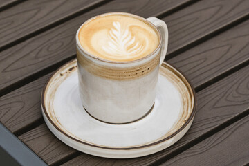 Cup of latte coffee or cappuccino in a cup. Shallow depth of field