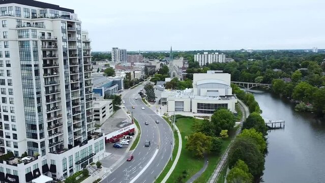 Drone Rise and Spiral around Downtown Condo Apartment by Speed River Shore and Main Street in Guelph Ontario, Canada