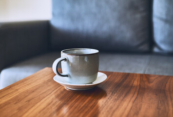Cup of coffee on a wooden table. Copy space