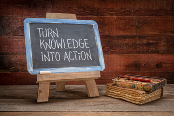 turn knowledge into action  - motivational advice on a vintage slate blackboard in a retro classroom