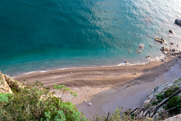 Empty beautiful beach on the Amalfi Coast, Campania, Italy, Europe. Summer holiday and vacation concept. Inspirational tropical paradise beach. Province of Salerno. Turquoise colored water. Hidden Gem