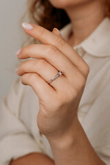 Obraz na płótnie Canvas Close-up of elegant diamond ring on female finger. Love and wedding concept.Soft and selective focus.