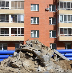 A pile of construction debris near a modern house